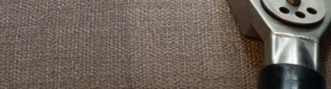 Professional upholstery cleaning service restoring a fabric sofa to like-new condition